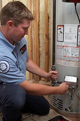 Technician working on a water heater