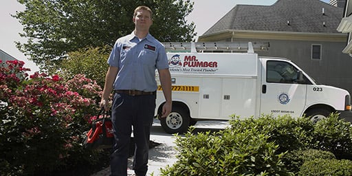 Plumber walking up to house with van in the background